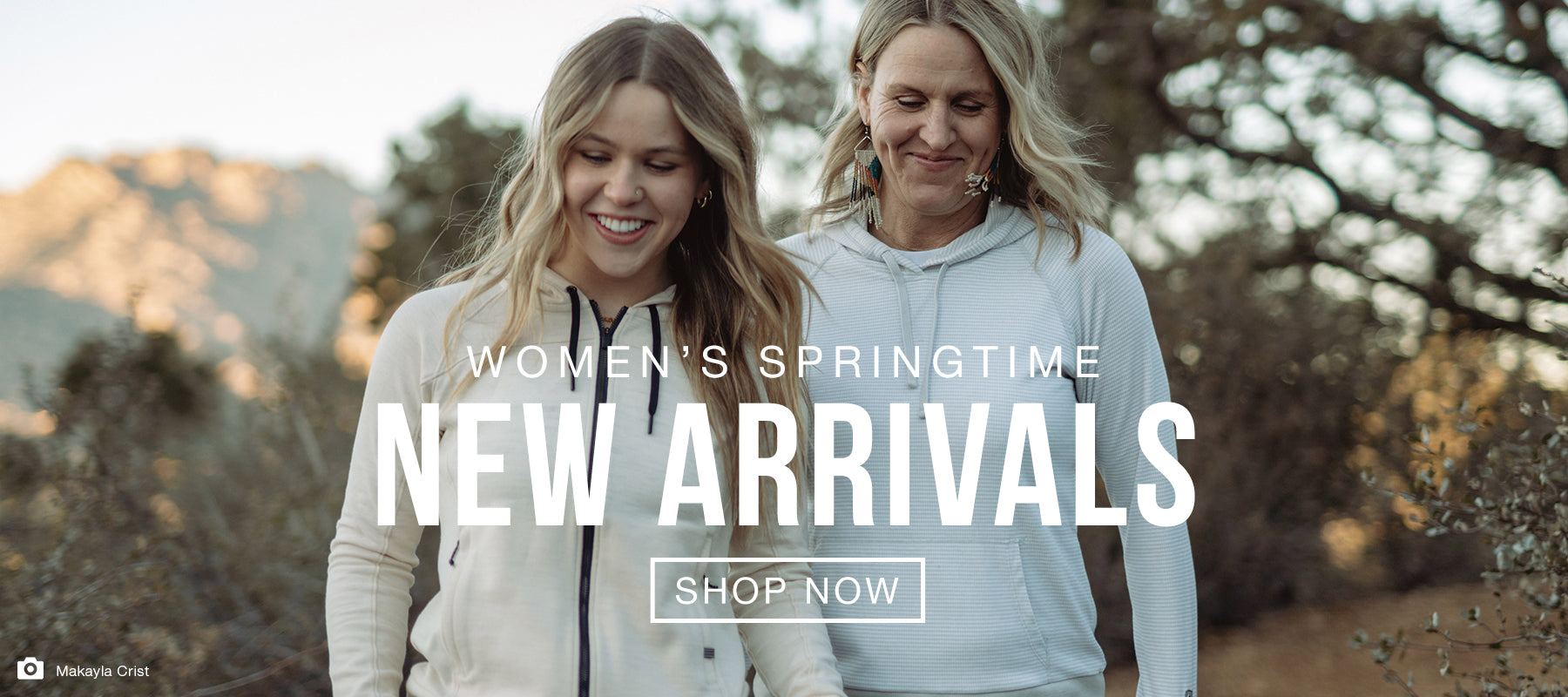 Shop Women's Springtime New Arrivals - A mother and daughter wearing hoodies while hiking a nature path with mountains in the background.